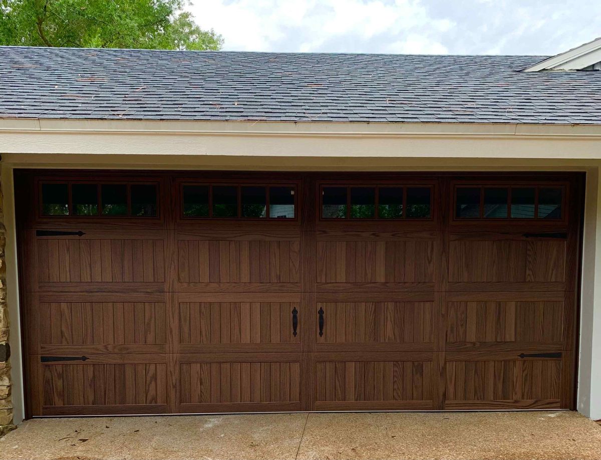A new wood-look garage door with window panels